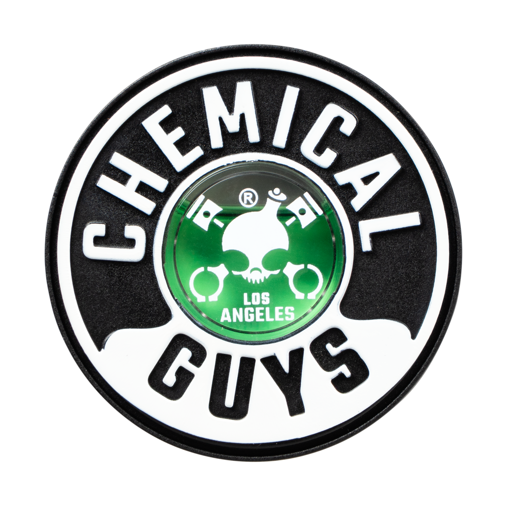 A round Chemical Guys logo patch or emblem on a plain white background. The design features the brand name 'CHEMICAL GUYS' in bold white letters on a black circular border, with a green center containing a skull and crossed tools above the words 'LOS ANGELES'.