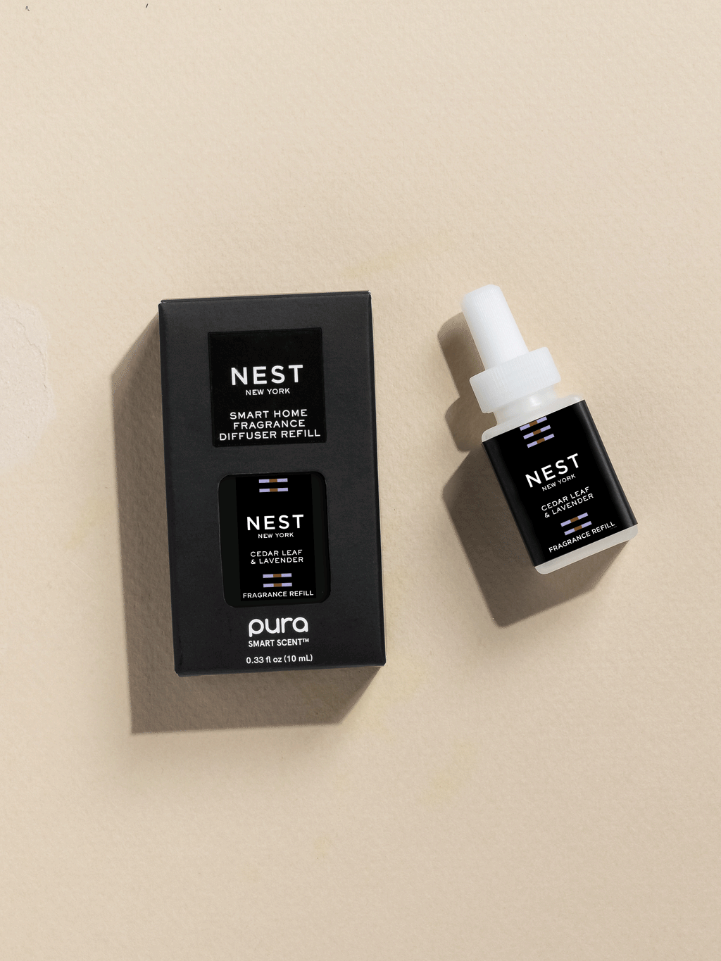 NEST New York Cedar Leaf and Lavender fragrance vial and packaging on a beige background