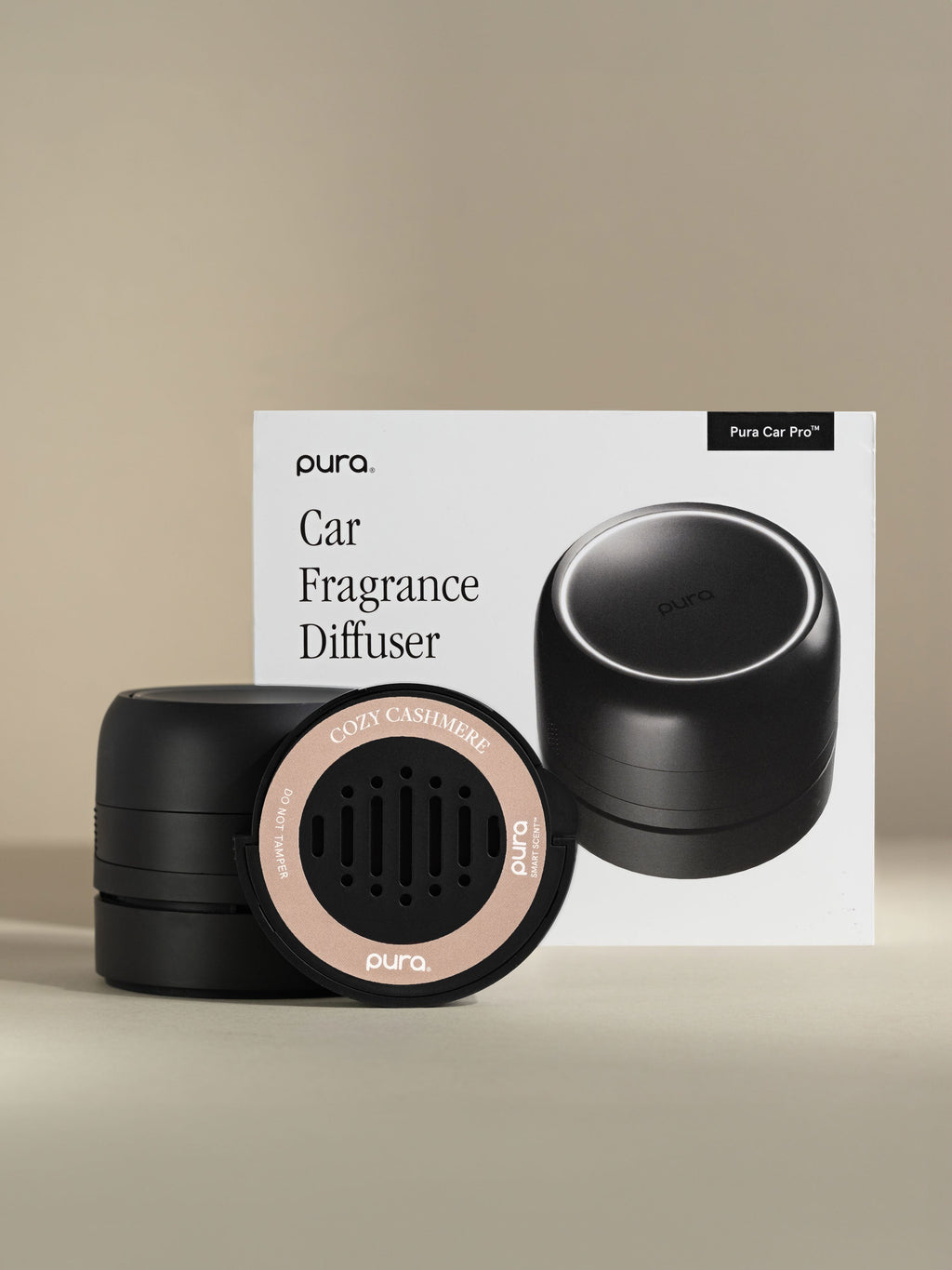 Pura Car Pro diffuser, Cozy Cashmere car fragrance, and packaging on a beige background