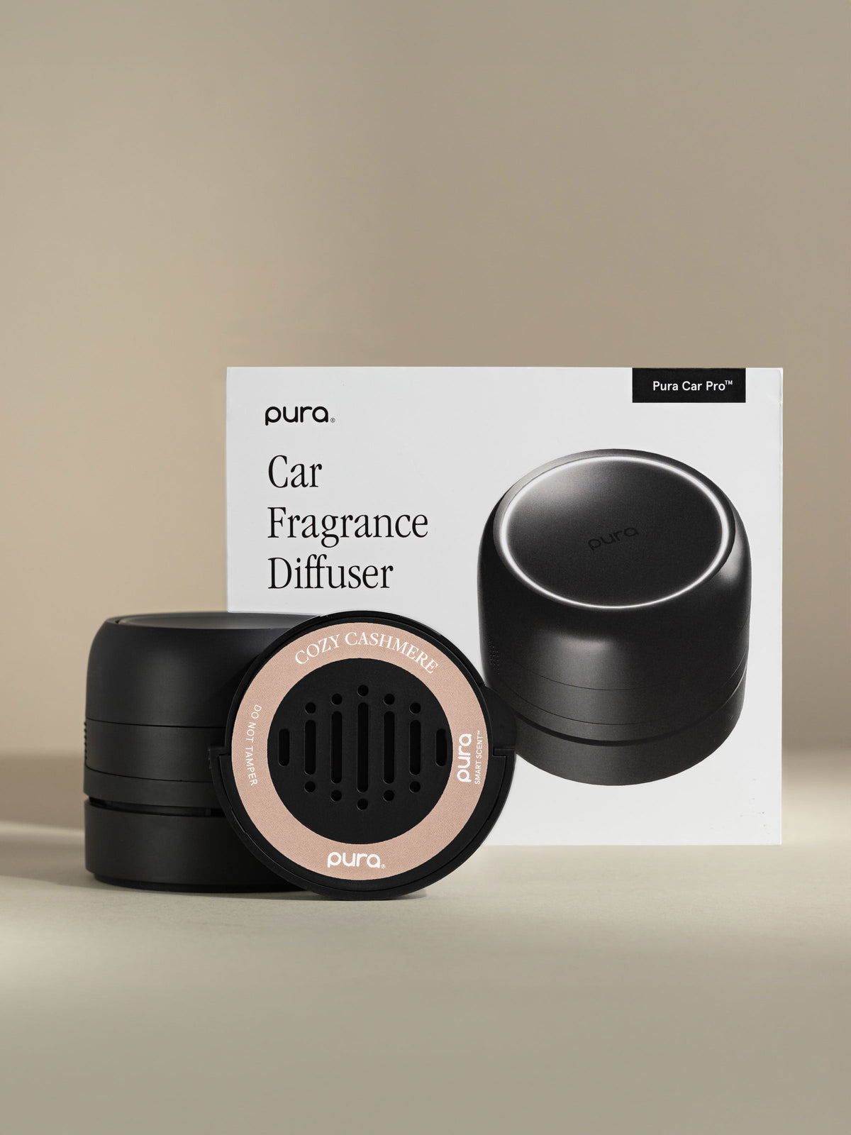 Pura Car Pro diffuser, Cozy Cashmere car fragrance, and packaging on a beige background