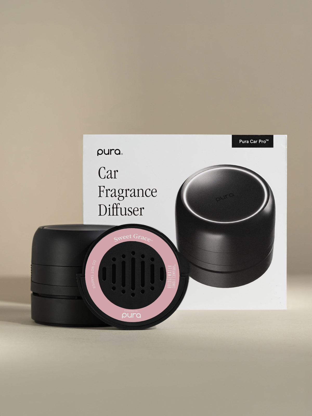 Pura Car Pro diffuser, Sweet Grace car fragrance, and packaging on a beige background