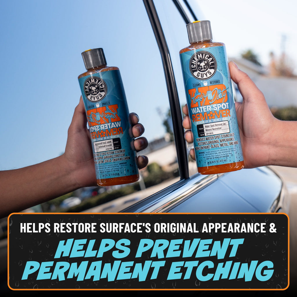 Two bottles of Heavy Duty Water Spot Remover held up outside car - helps restore surface's original appearance and helps prevent permanent etching